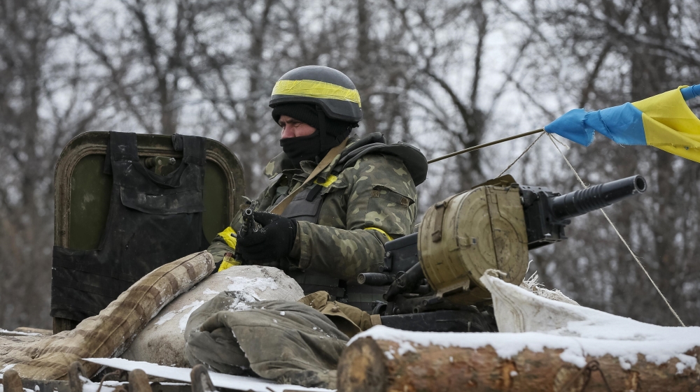 A member of the Ukrainian armed forces rides on an armoured personnel carrier (APC) near Debaltseve