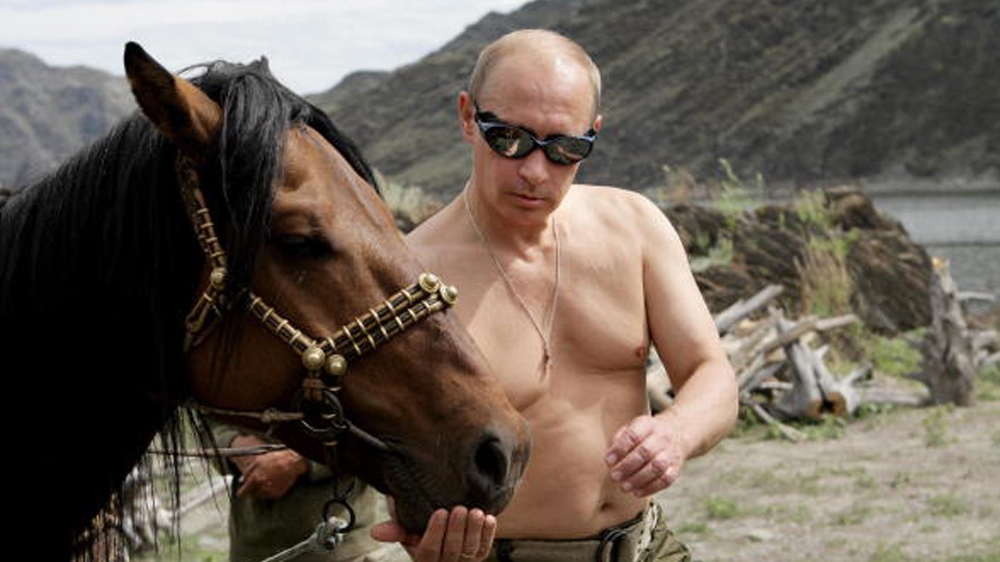 Russian Prime Minister Vladimir Putin is pictured with a horse during his vacation outside the town of Kyzyl in Southern Siberia on August 3, 2009.