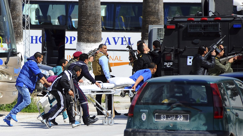 Escorted by security forces, rescue workers pulled an empty stretcher outside the Bardo museum on Wednesday [AP]