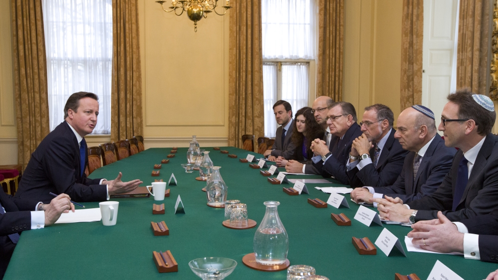 British PM David Cameron talks with members of the Jewish Leadership Council [AP]