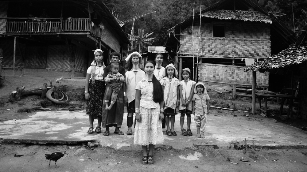 Nineteen year old Mu Pau, centre, wants to move to Finland and study to become a doctor. A Finnish team interviewed her and her family for asylum, but the Thai authorities refused to let them go. Mu Pau's mother, Mu Mo, has seven children and is desperate to give them chances she never had. Mu Pau would like to follow the other girls and take off her rings in protest, but the family cannot afford to lose her wage as an exhibit [Jack Picone] 