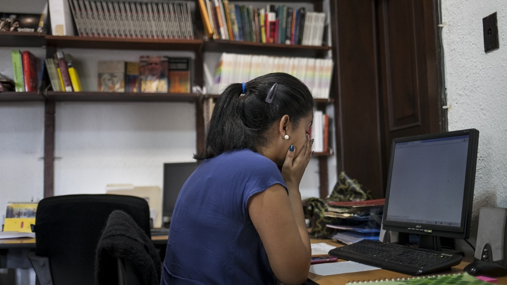 Before having Sofia, Carla had a good job at Proctor & Gamble and felt that people respected her. She now works as an administrator and, although this job doesn't pay benefits or social security, her employer is more understanding when she occasionally needs to bring her daughter into work with her [Santi Donaire/Al Jazeera] 