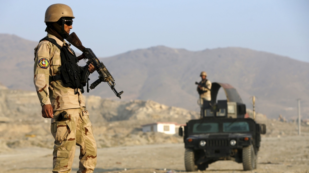 Afghan policemen stand guard at a checkpoint in the Deh Sabz district of Kabul, Afghanistan [REUTERS]
