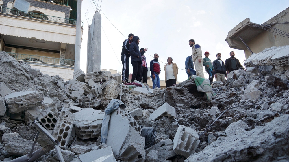 Residents inspect a damaged site from what activists said were air strikes carried out by the Russian air force in Nawa city, Deraa, Syria [Reuters/Alaa Al-Faqir]