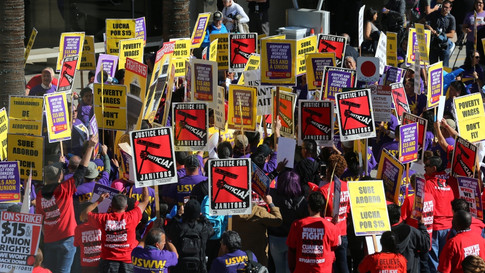 Demonstrators participate in the "Fight for $15" wage protest at San Diego International Airport in San Diego, California