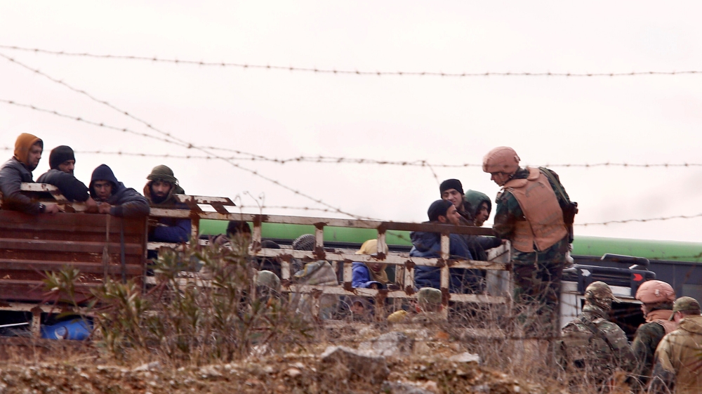 Russian soldiers inspect rebels and civilians who were evacuated from rebel-held eastern Aleppo [Reuters]