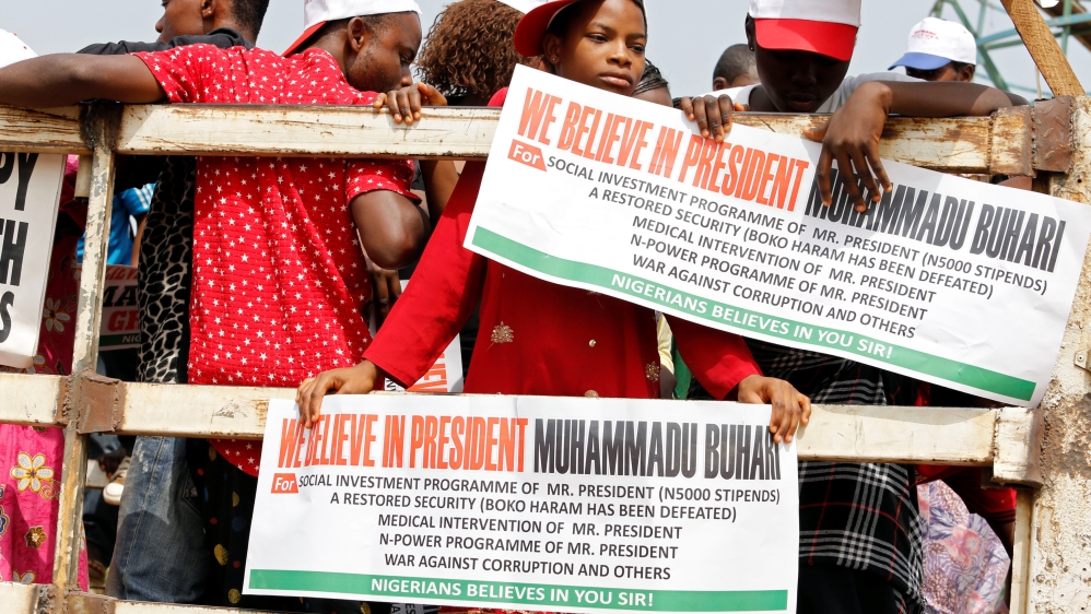 People hold placards during a rally to show support for Nigeria''s President Muhammadu Buhari in Abuja