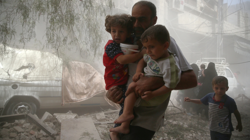 Residents flee a site after an air strike on the rebel-held besieged town of Douma, eastern Damascus suburb of Ghouta