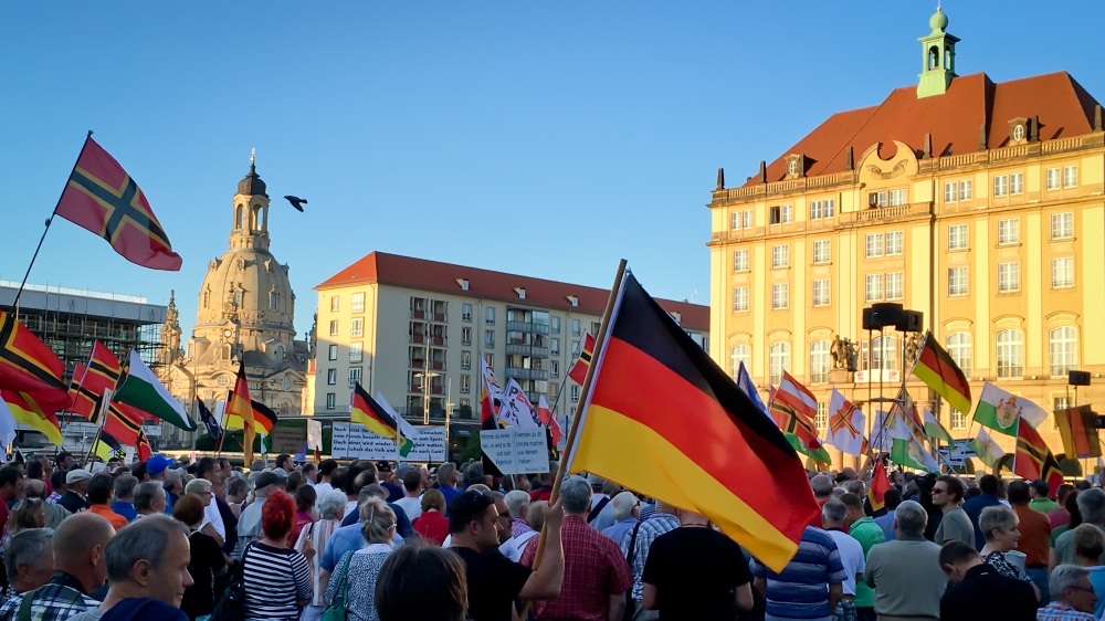 Supporters of PEGIDA, the right-wing, anti-Muslim, anti-refugee movement, protest every week in Dresden [Jacob Kushner/Al Jazeera]
