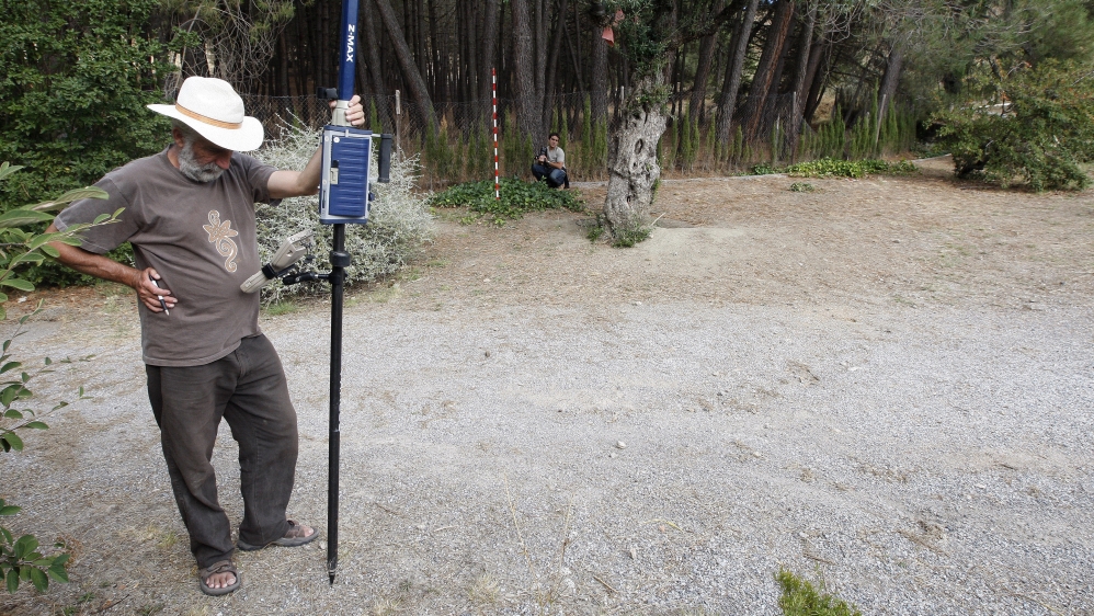 A member of the Andalusian Geophysics Institute works with GPS equipment in the site where it is believed that the remains of Spanish writer Federico Garcia Lorca are buried, in Alfacar, near Granada [Pepe Marin/Reuters]