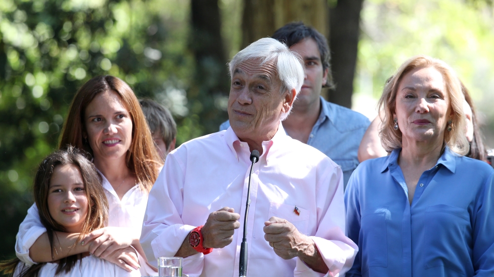 Chilean presidential candidate Pinera with his grandchildren and his wife Morel speaks to the media after voting in a public school during the presidential election, in Santiago