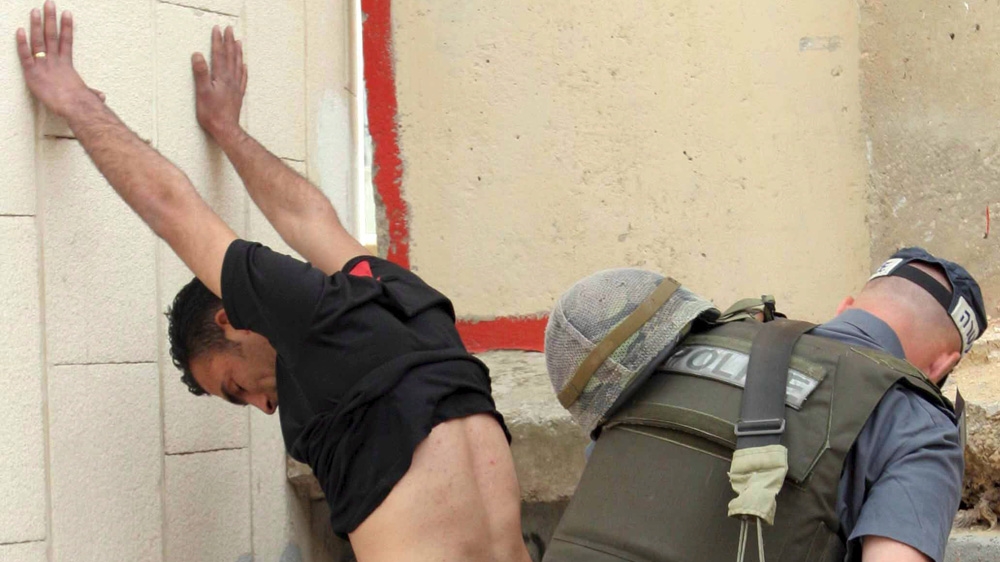 Israeli border police searches Palestinian