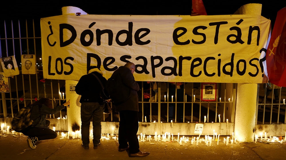 A banner outside Chile's national stadium reads, 'Where are the disappeared?' [Ivan Alvarado/Reuters]