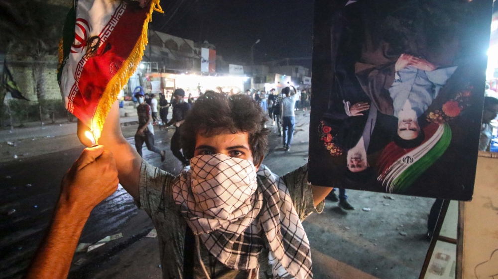 Protesters torched the Iranian consulate in Basra as part of protests over poor public services [Haider Mohammed Ali/AFP]