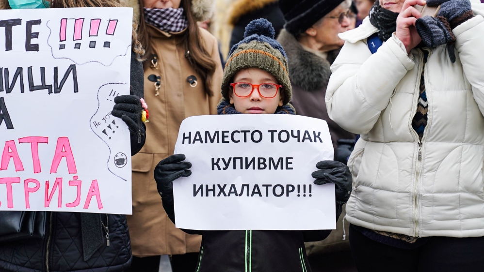“Instead of a bike, buy me an inhaler,” says the poster held by the young child. Weekly protests are organized by the Cancerogenous Society, which advocates for clean air in Skopje.