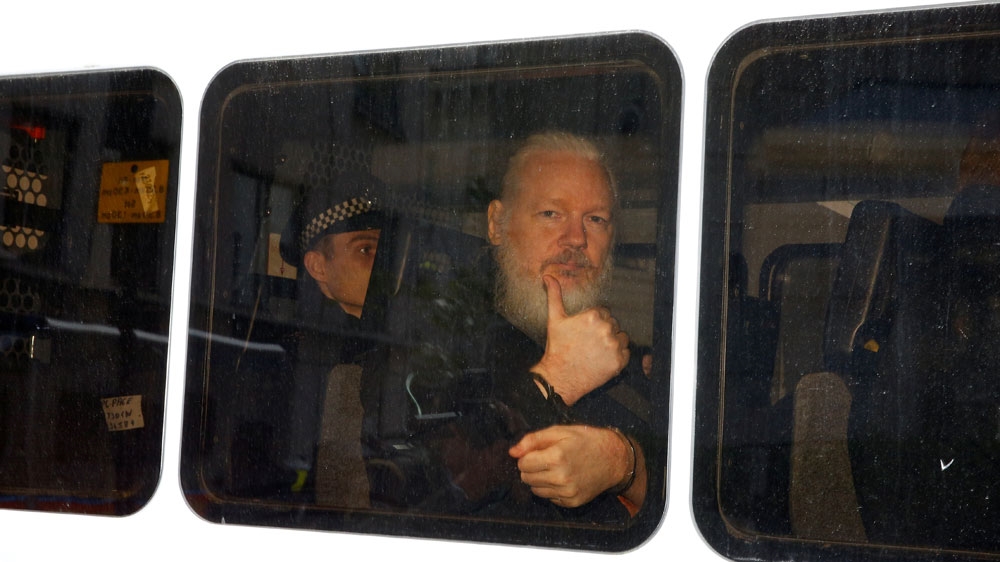 Assange is seen in a police van after his arrest by British police at the Ecuadorian embassy in London