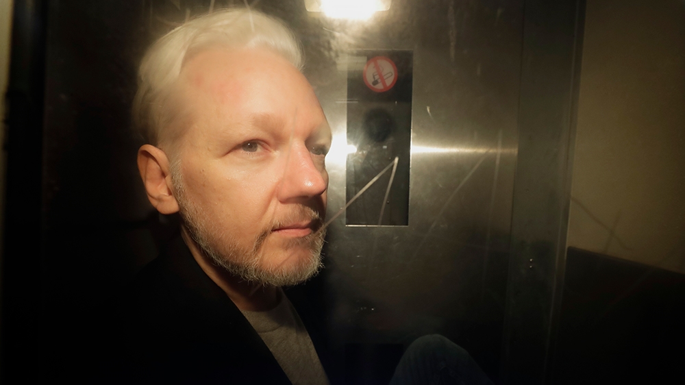 WikiLeaks founder Julian Assange being taken from court, where he appeared on charges of jumping British bail seven years ago, in London, Wednesday May 1, 2019. Assange has been jailed for 50 weeks fo