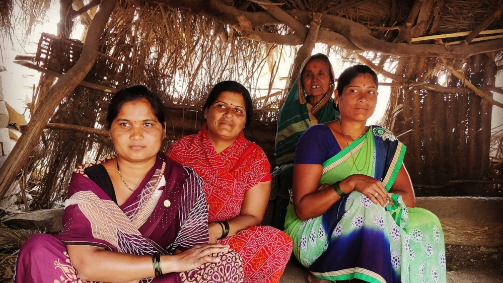 Gayabai Mugle, 60, with poses with her daughters-in-law. She was unaware that using a piece of cloth during menstruation instead of a sanitary pad caused infections.