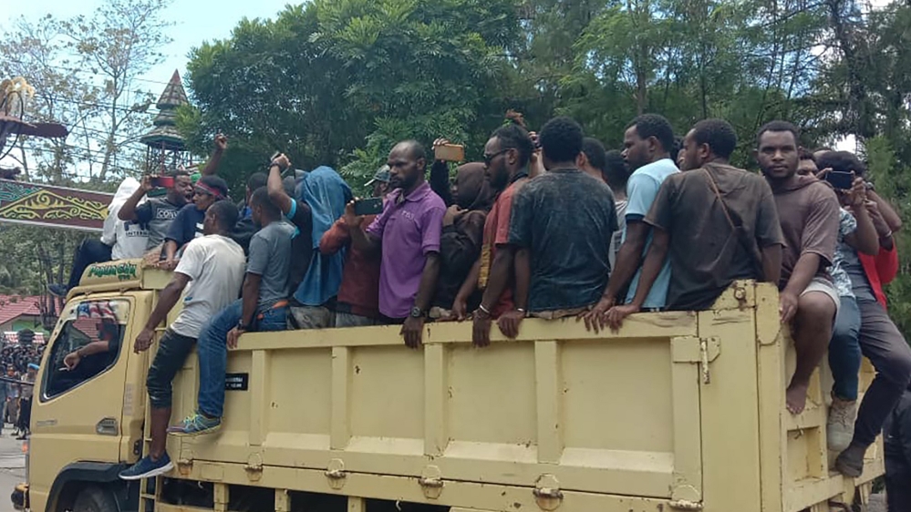 Papuan protesters ride a truck as they gather at a university in provincial capital Jayapura on Monday