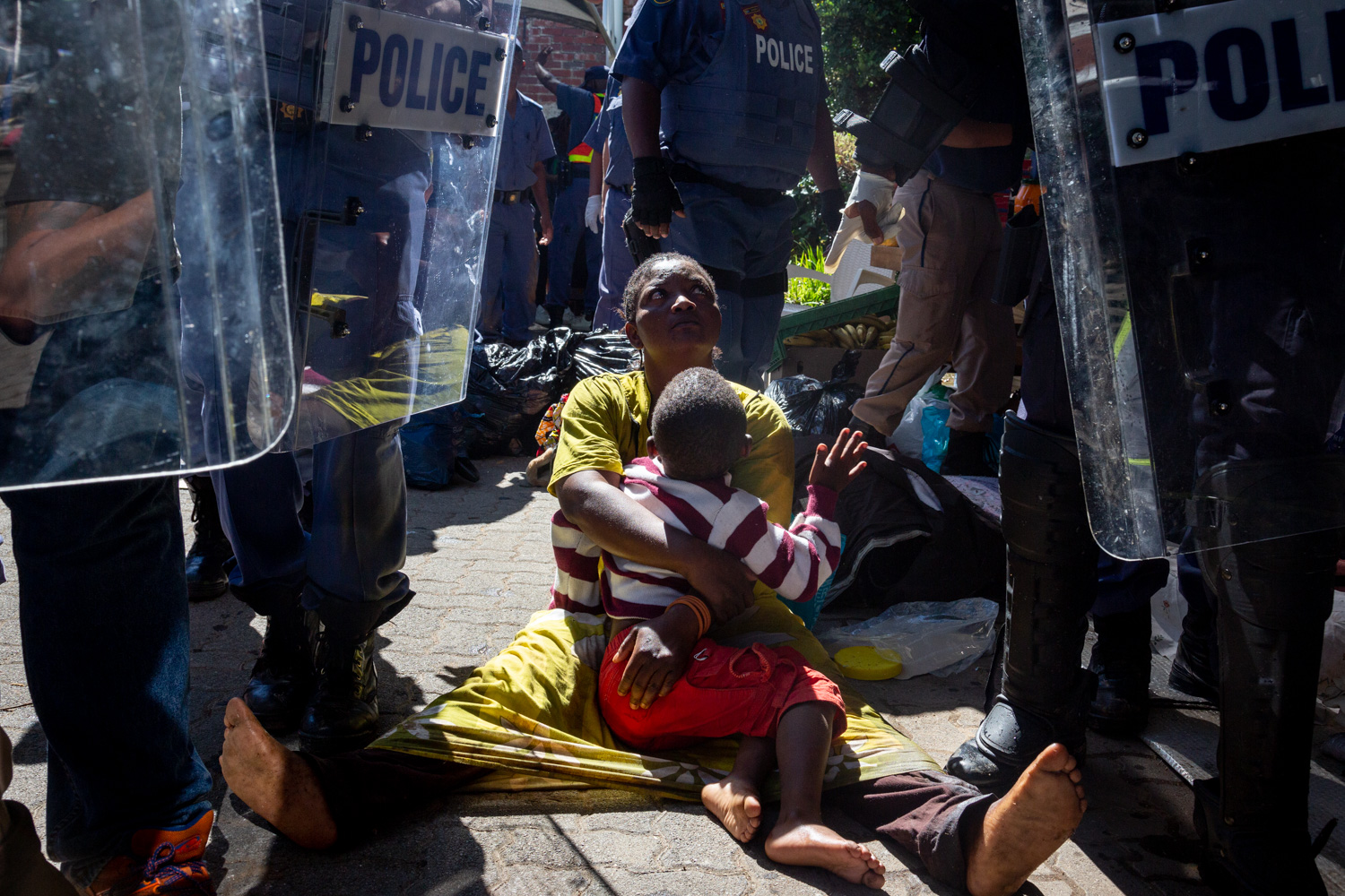 A refugee holds on to her daughter as police make arrests around her at the UNHCR offices in Waterkloof, Pretoria in November 2019