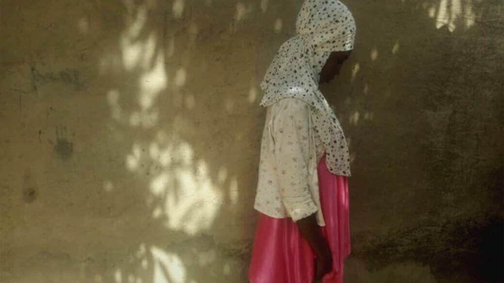 Roda stands just outside her temporary home in Madinatu