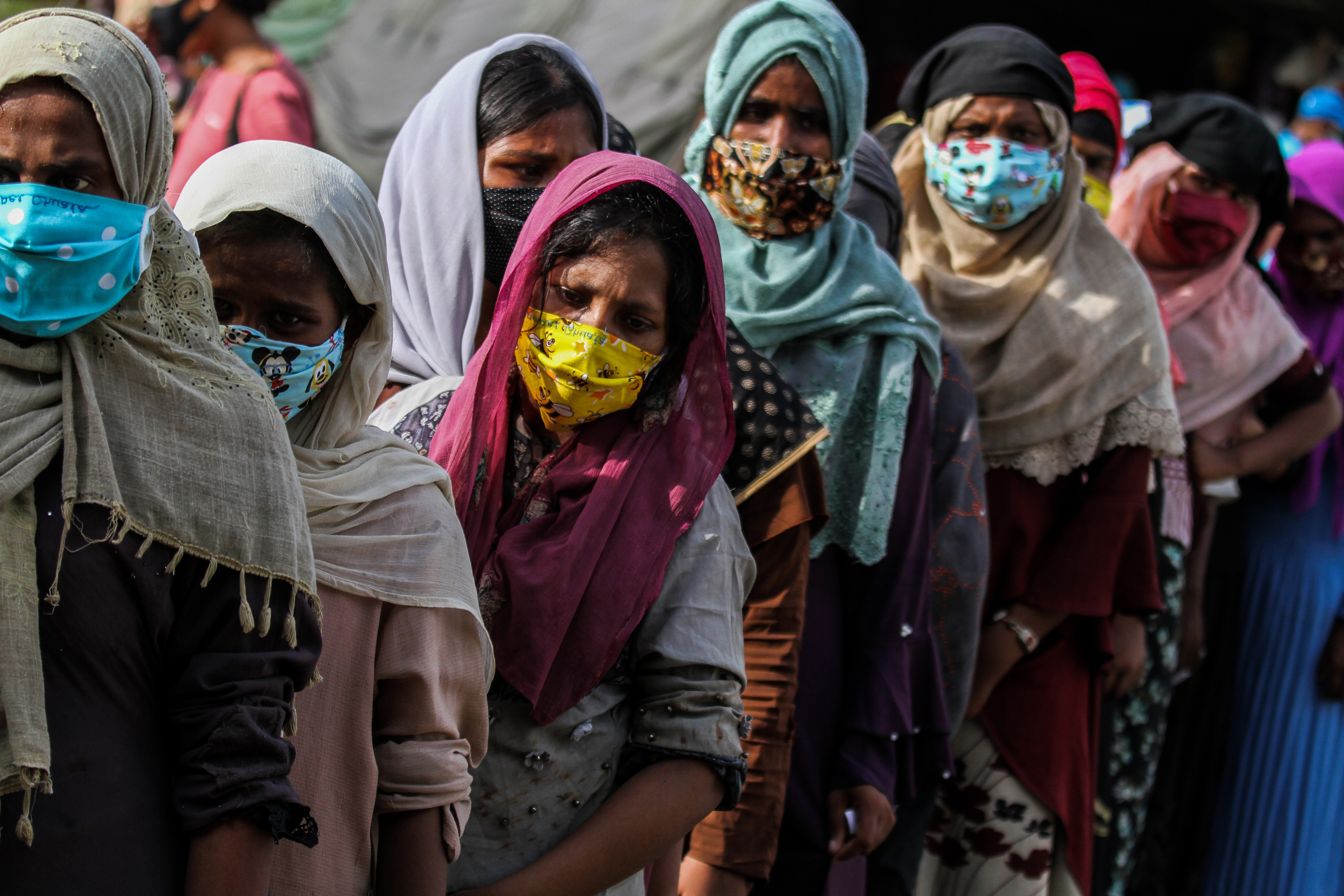 Rohingya refugees wait to take a rapid test for COVID-19 after arriving at the building being used as a temporary shelter for refugees and migrants stranded in Ujong Blang Beach, Aceh, Indonesia [Fachrul Reza/Barcroft Media via Getty Images]