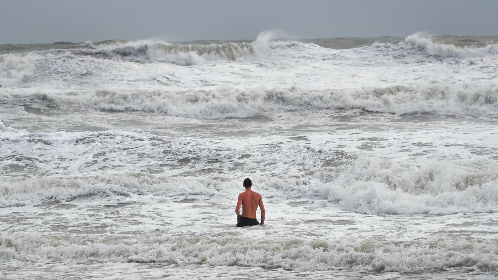 A swimmer explores the waves during high tide as Hurricane Dorian churns offshore on September 3, 2019 in Indialantic, Florida