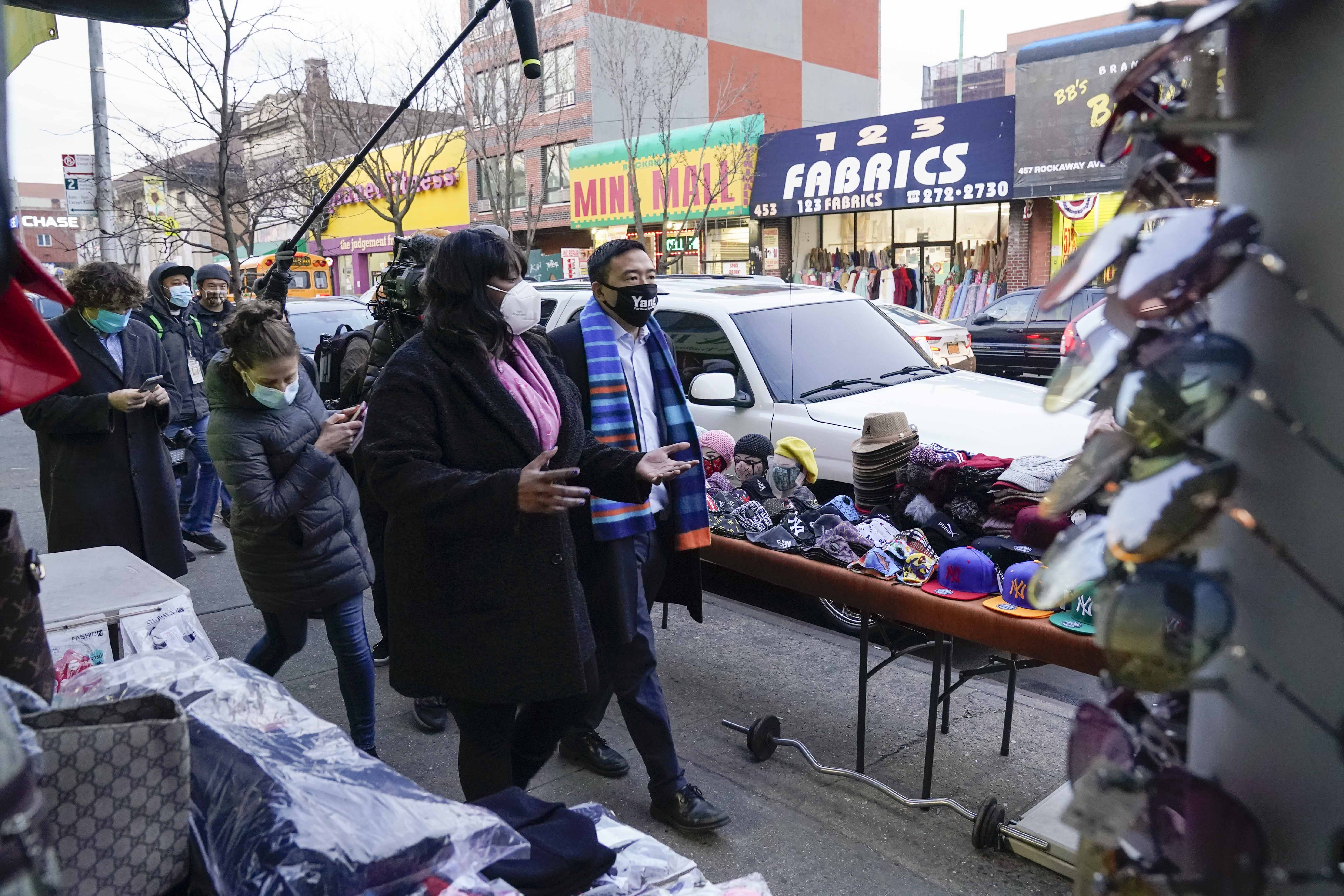 Andrew Yang walks with New York State Assembly member Latrice Walker on January 14, 2021, in the Brooklyn borough of New York. Yang, a former presidential candidate, has officially entered the race for mayor of New York City [File: AP/Frank Franklin II]