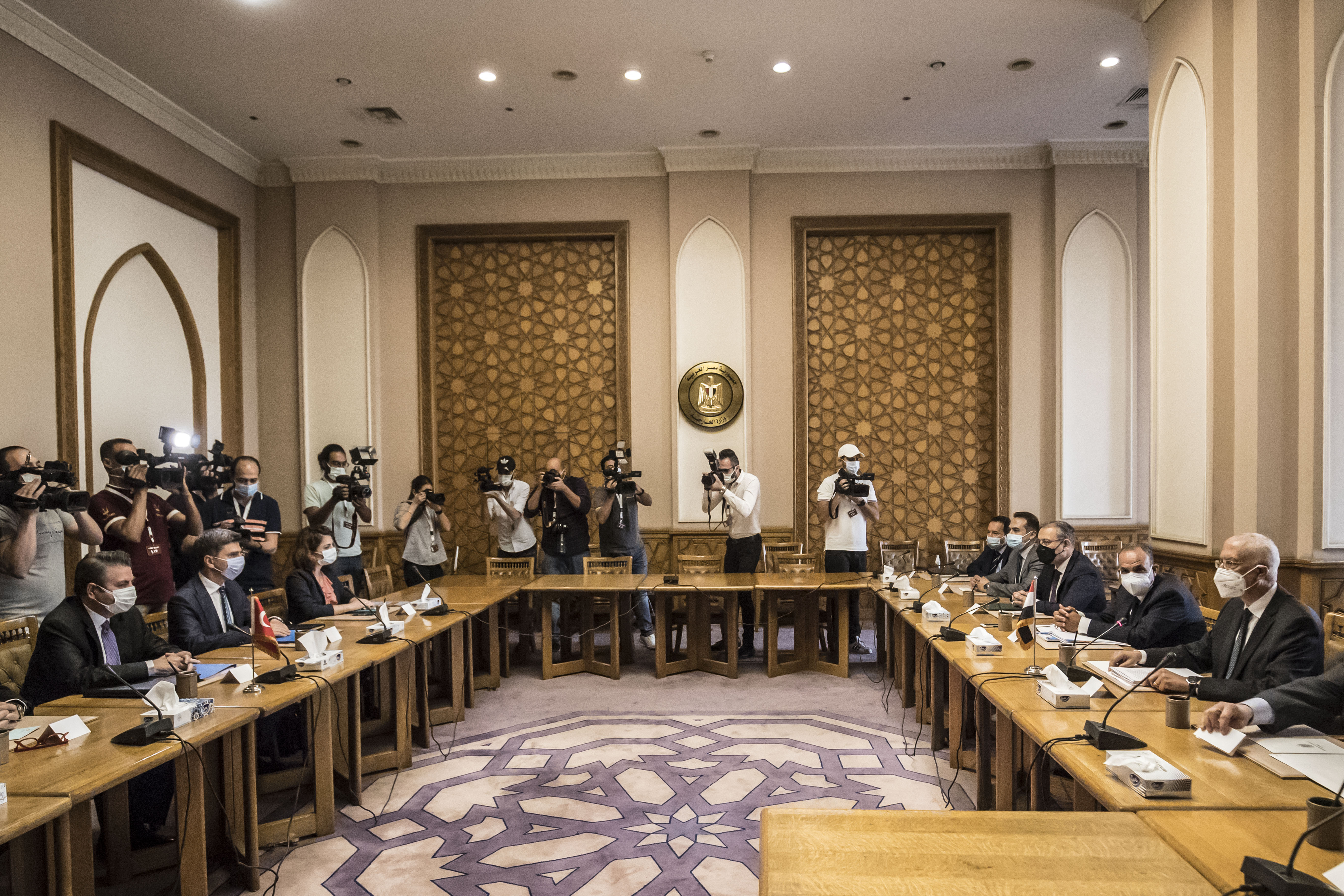 Egypt's Deputy Foreign Minister Hamdi Sanad Loza, right, meets with his Turkish counterpart Sedat Onal and his delegation, left [Khaled Desouki/AFP]