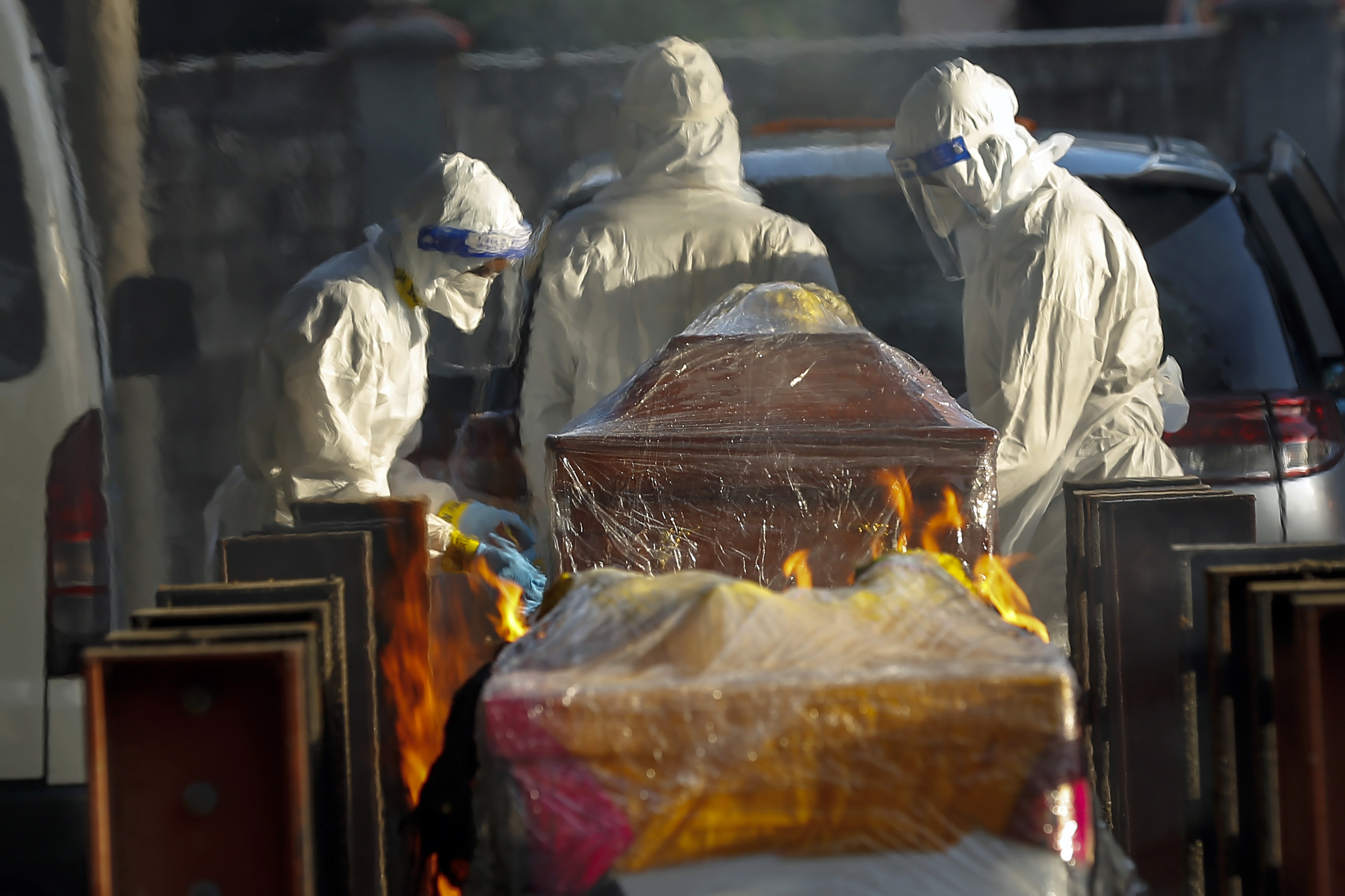 Funeral workers prepare for a cremation process for COVID-19 victim in Kuala Lumpur, Malaysia