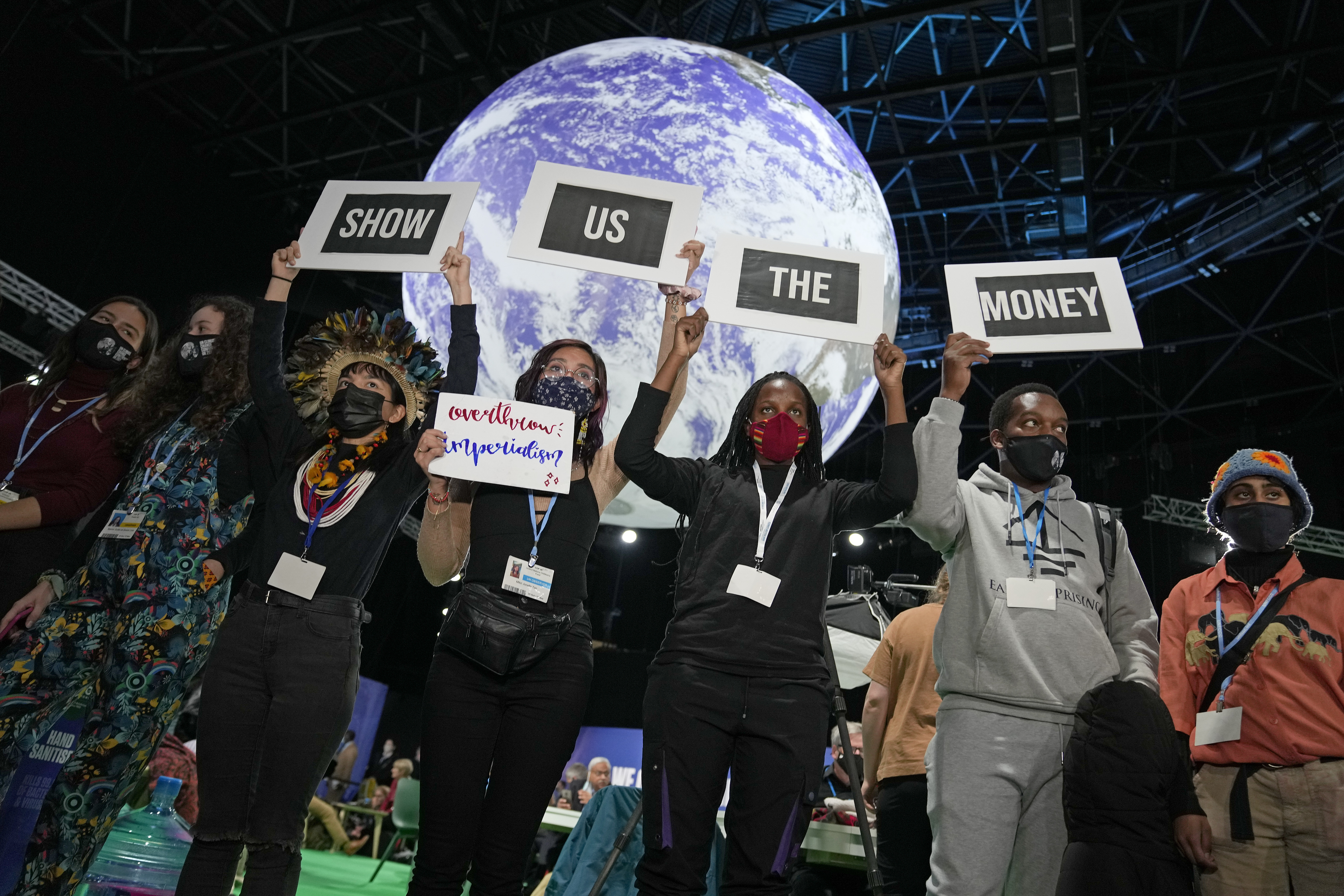 Climate activist Vanessa Nakate, third right, and other activists engage in a 'Show US The Money' protest at the COP26 United Nations Climate Summit in Glasgow, Scotland on Monday, November 8, 2021. The summit gathers leaders from around the world, in Scotland's biggest city, to lay out their vision for addressing the common challenge of global warming [AP Photo/Alastair Grant]