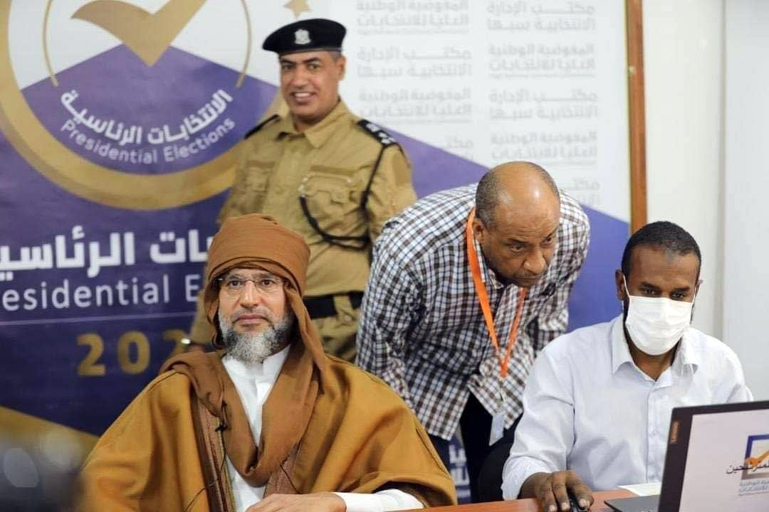 Saif al-Islam Gaddafi (left), son of former Libyan leader Muammar Gaddafi, registers to run in presidential elections in 2021 [Libyan Electoral Commission Handout via EPA-EFE]