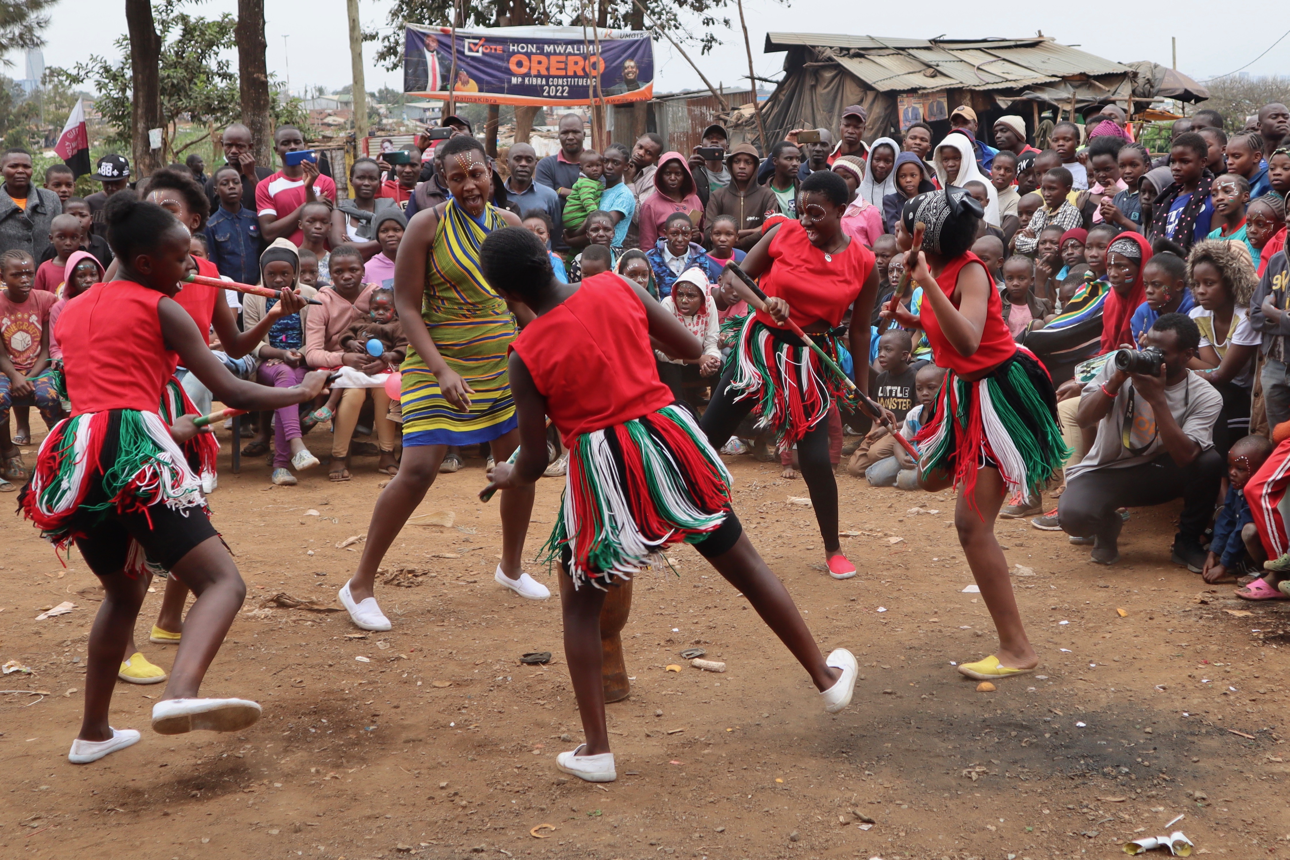 Dancers perform for the crowd at a peace initiative in Kibera
