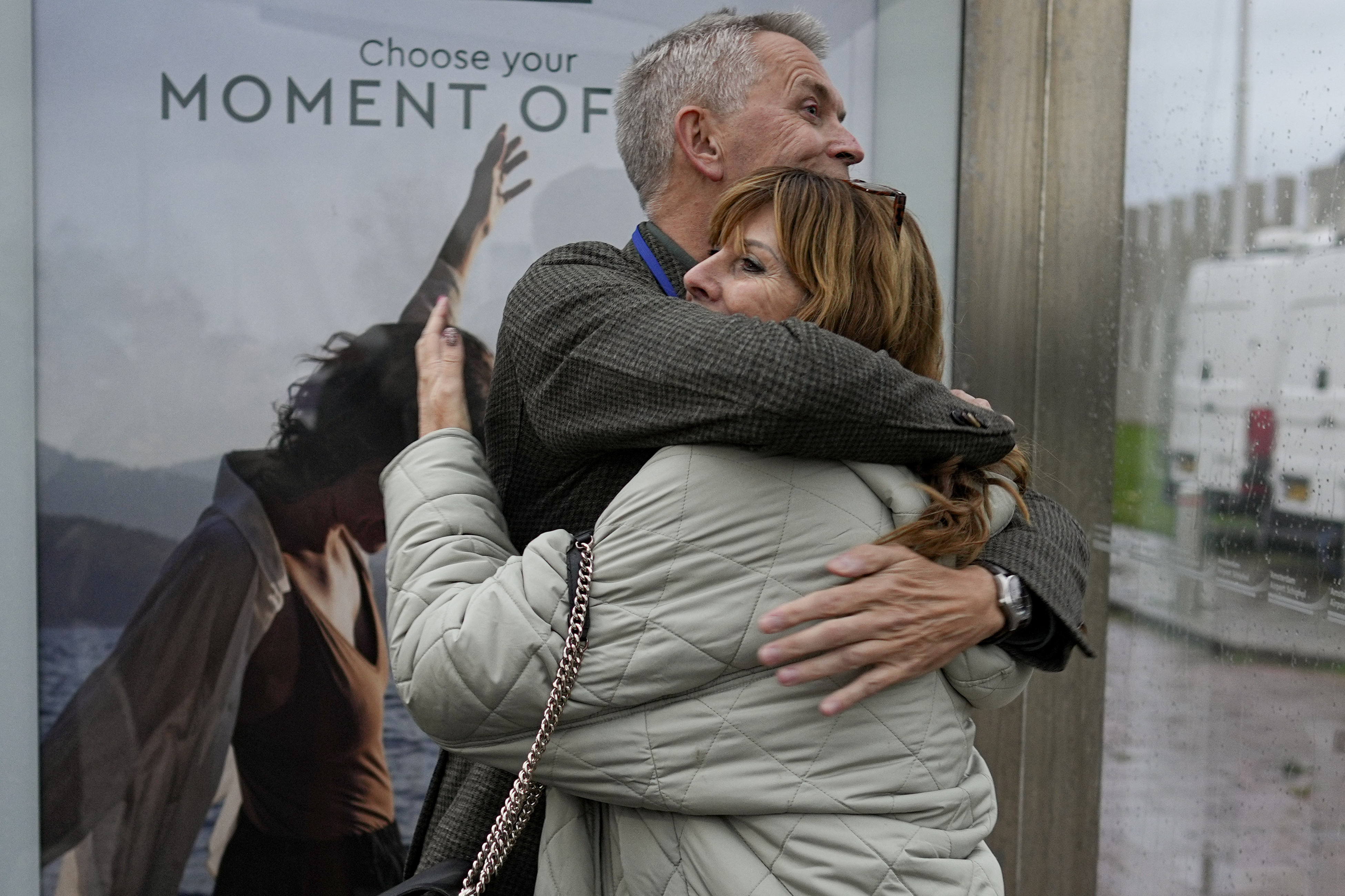 People who lost relatives in the downing of MH17 are seen hugging after Thursday's court verdict