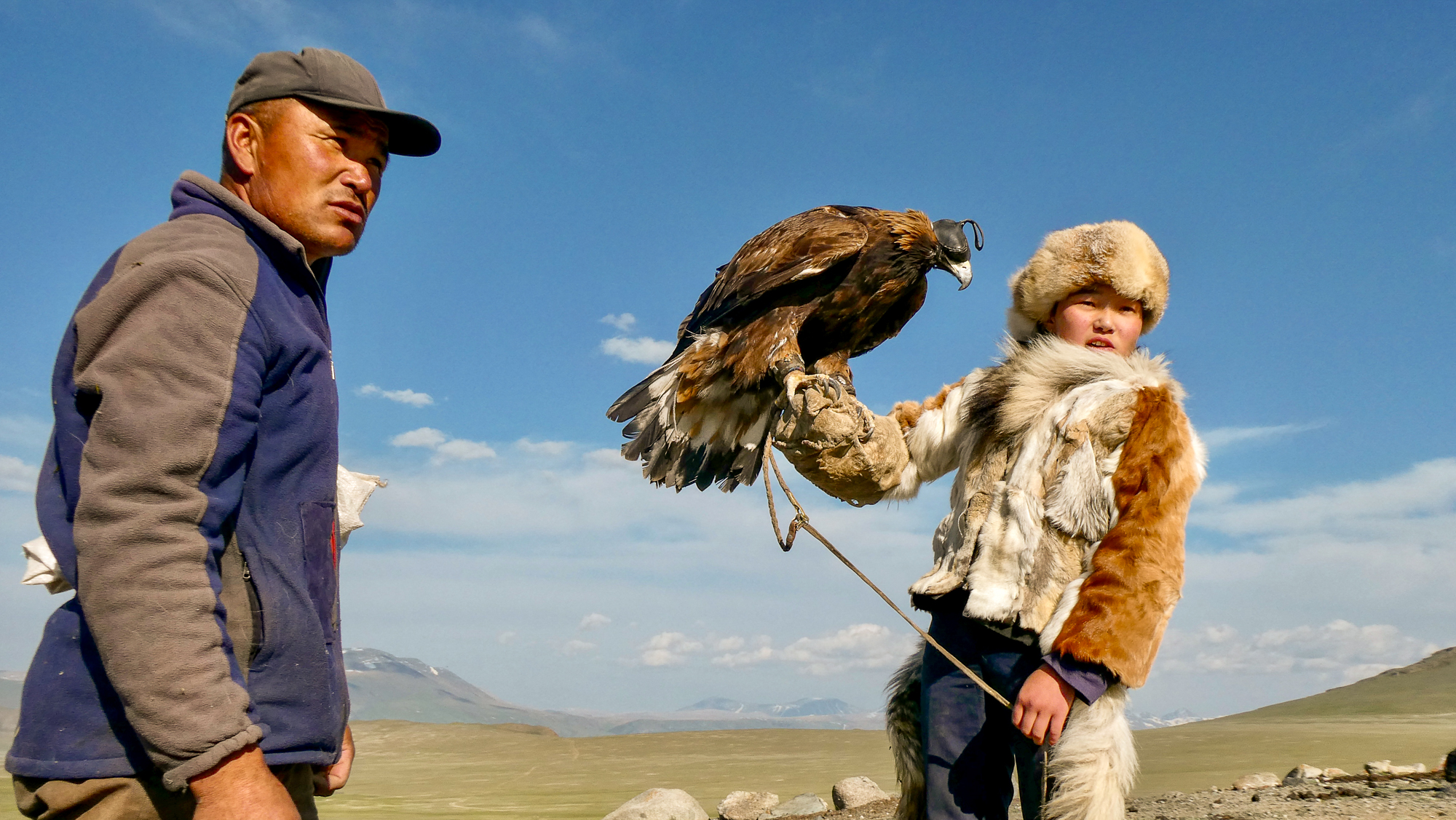 Shokhan, a prize-winning eagle hunter in Altai, started learning the Kazakh tradition as a teenager. He helps his daughter hold the bird