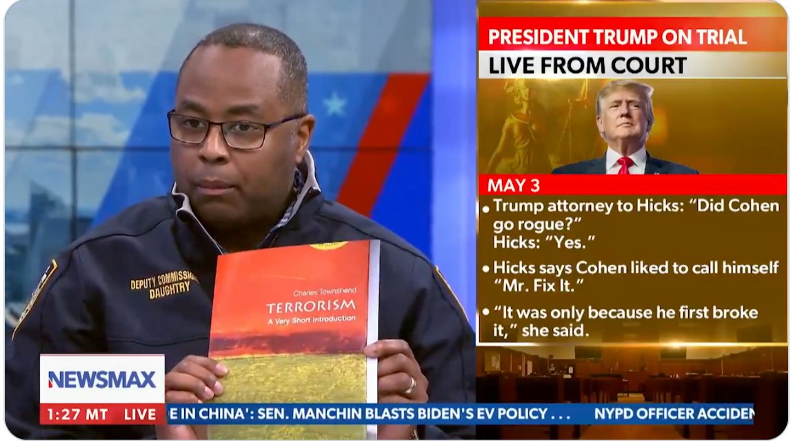 NYPD Deputy Commissioner Kaz Daughtry shows the book titled 'Terrorism: A Very Short Introduction' as evidence of some kind of foreign, radicalising influence on student activism [Newsmax/Screengrab]