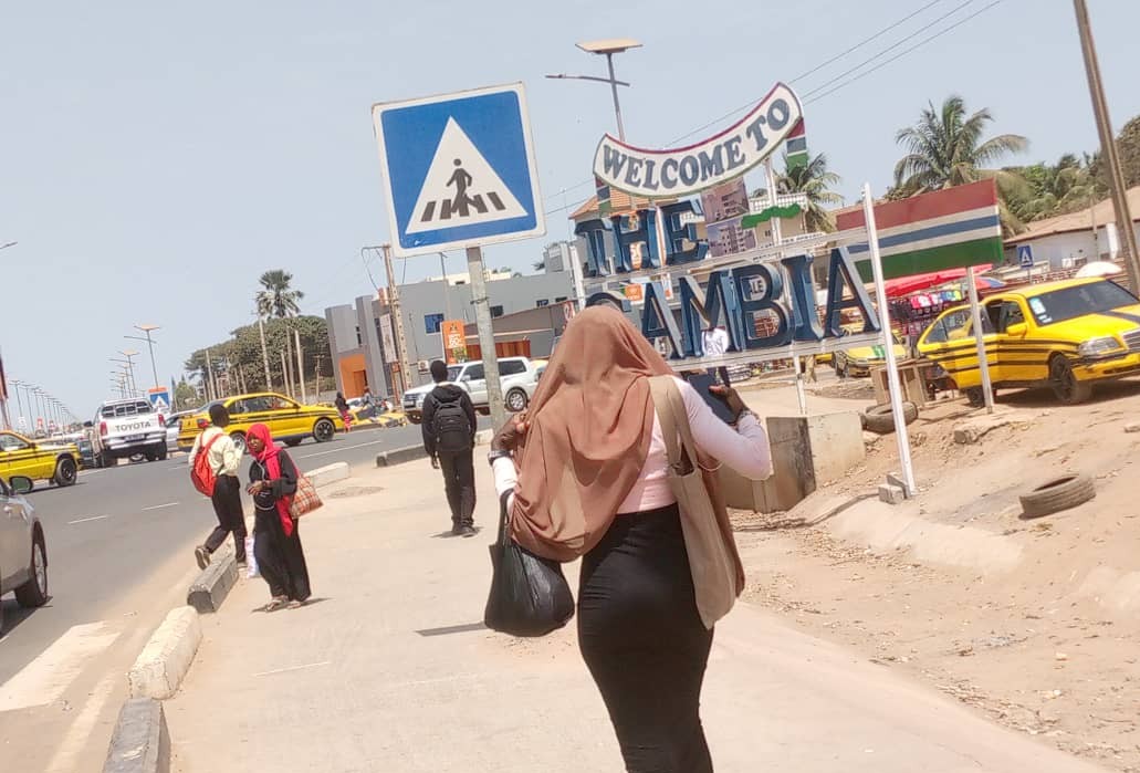 People walking on a street in Banjul, The Gambia.