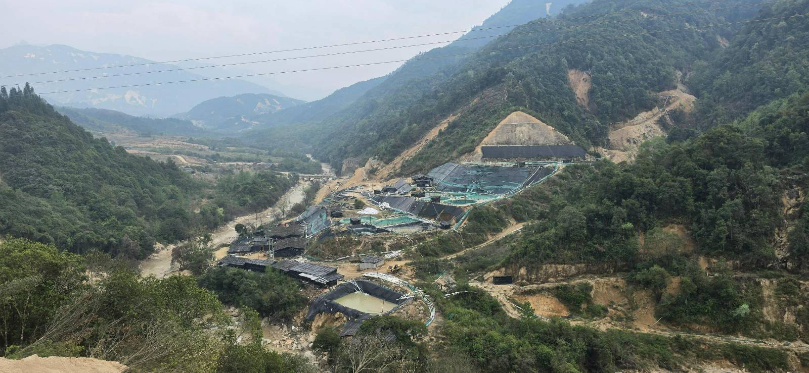 A rare earths mine occupies a hillside.