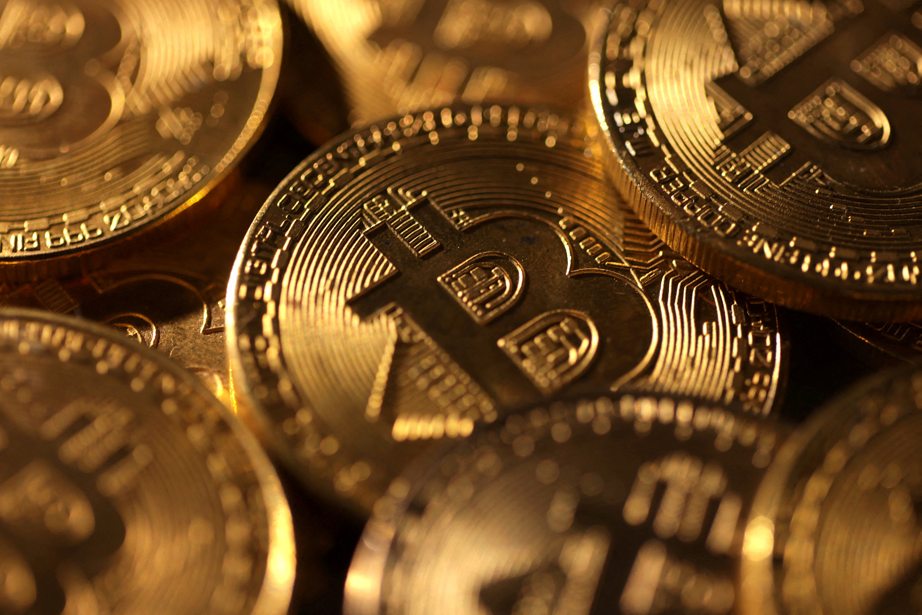 Representations of cryptocurrency bitcoin are seen.