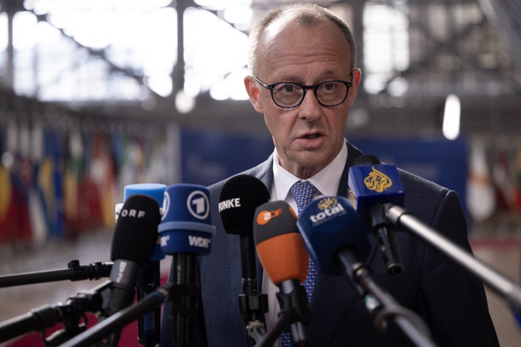 Germany's Chancellor Friedrich Merz speaks to journalists as he arrives for a EU Summit at the EU headquarters in Brussels, on March 19, 2026. European Union leaders meet in the context of the US-Israeli war against Iran that is consuming the Middle East, and its consequences on energy prices and security. (Photo by JOHN THYS / AFP)