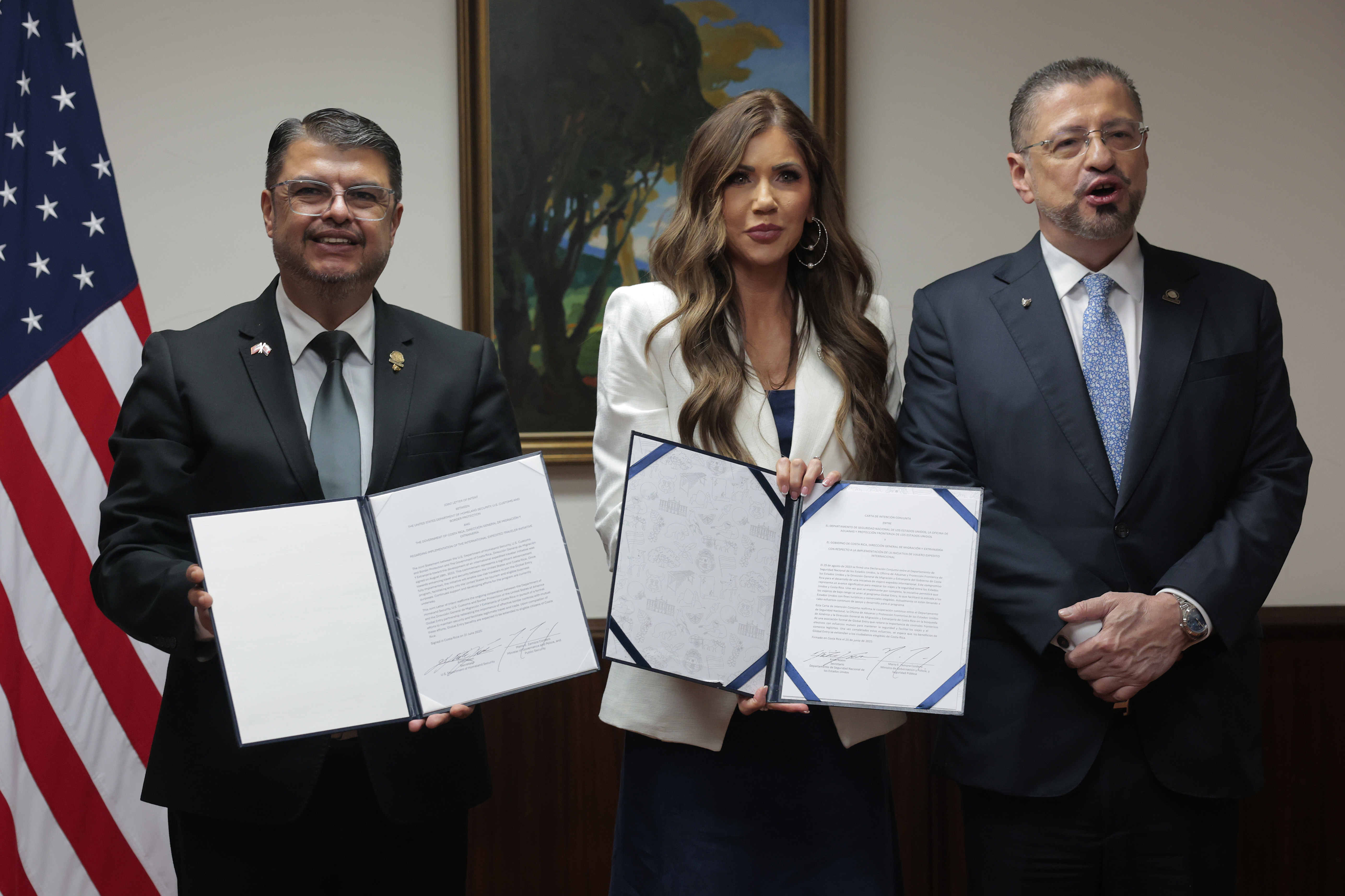 SAN JOSE, COSTA RICA - JUNE 25: U.S. Homeland Security Secretary Kristi Noem, President of Costa Rica Rodrigo Chaves Robles (R) and Costa Rica Minister of Public Security Mario Zamora Cordero (L) participates in a signing ceremony for the Global Entry Letter of Intent at the Casa Presidencial on June 25, 2025 in San Jose, Costa Rica. Noem continues her visits to several Central American countries today, meeting with political leaders and learning about immigration programs and facilities supported by the U.S. Department of Homeland Security, with a focus on U.S. security cooperation initiatives in the region. (Photo by Anna Moneymaker/Getty Images)