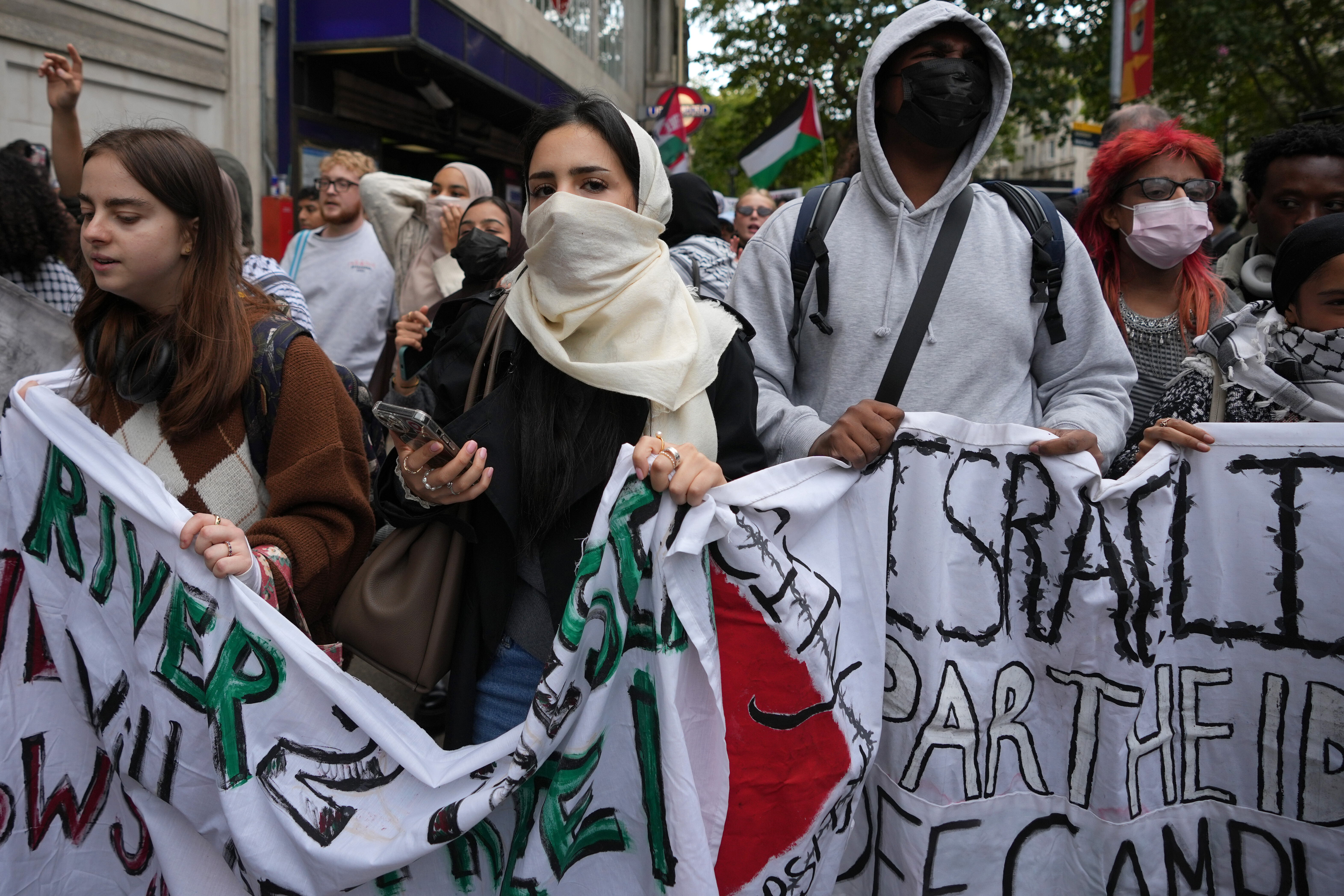 Students demonstrate holding banners, placards and flags during an Inter-university march for Gaza in London, on Tuesday, October 7, 2025