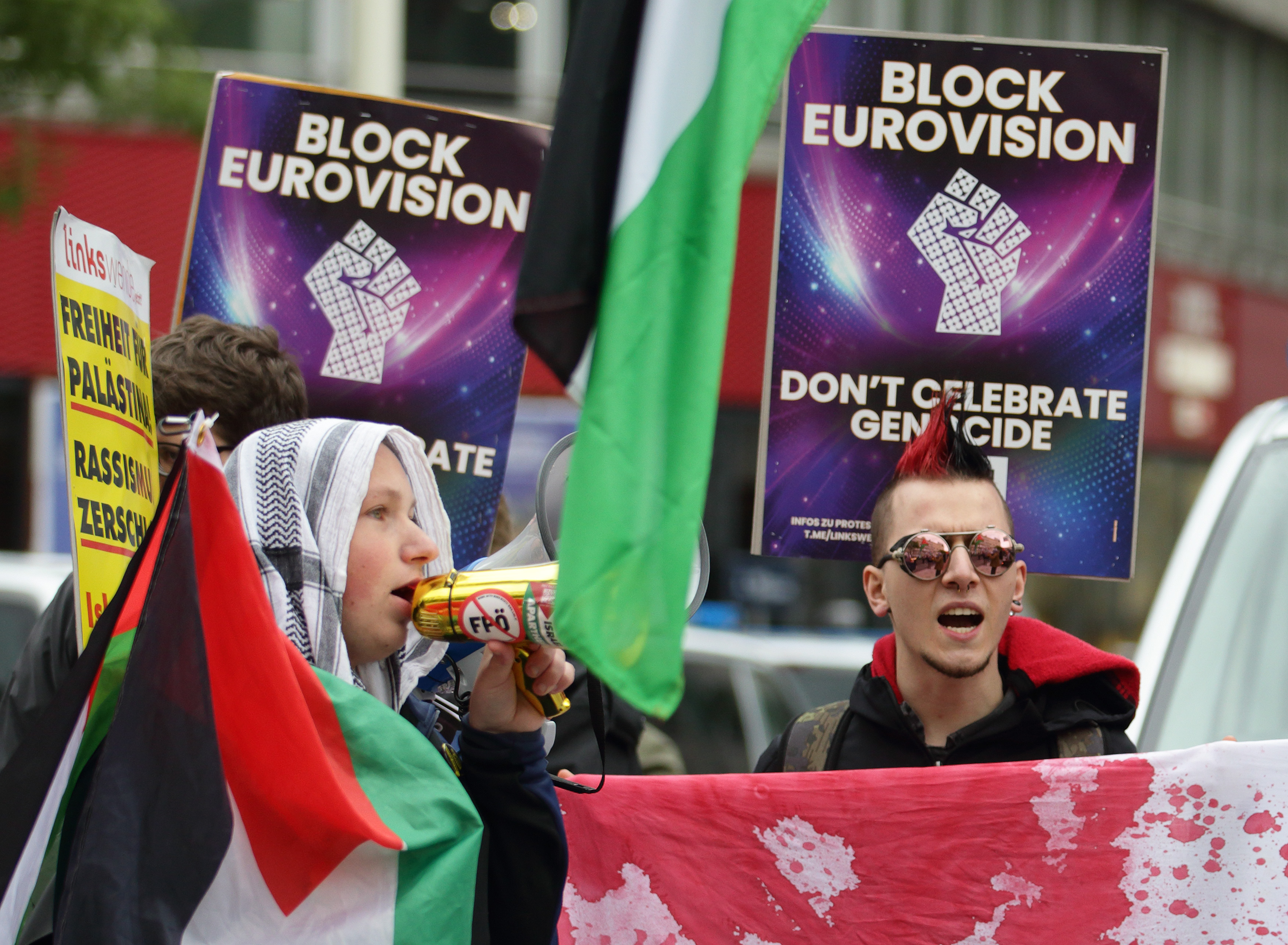 VIENNA, AUSTRIA - MAY 16: Pro-Palestinian and Iranian activists gather to demonstrate against Israel's participation in this year's Eurovision Song Contest on May 16, 2026 in Vienna, Austria. Demonstrators are calling for Israel's exclusion over the war in Gaza and accuse Eurovision organizers of double standards, noting that Russia was barred in 2022 while Israel remains in the competition. This year's Eurovision marks its 70th anniversary in Vienna, but the competition has been overshadowed by controversy, with five countries - Spain, Ireland, the Netherlands, Slovenia and Iceland - boycotting the contest in protest over Israeli participation. (Photo by Heinz-Peter Bader/Getty Images)