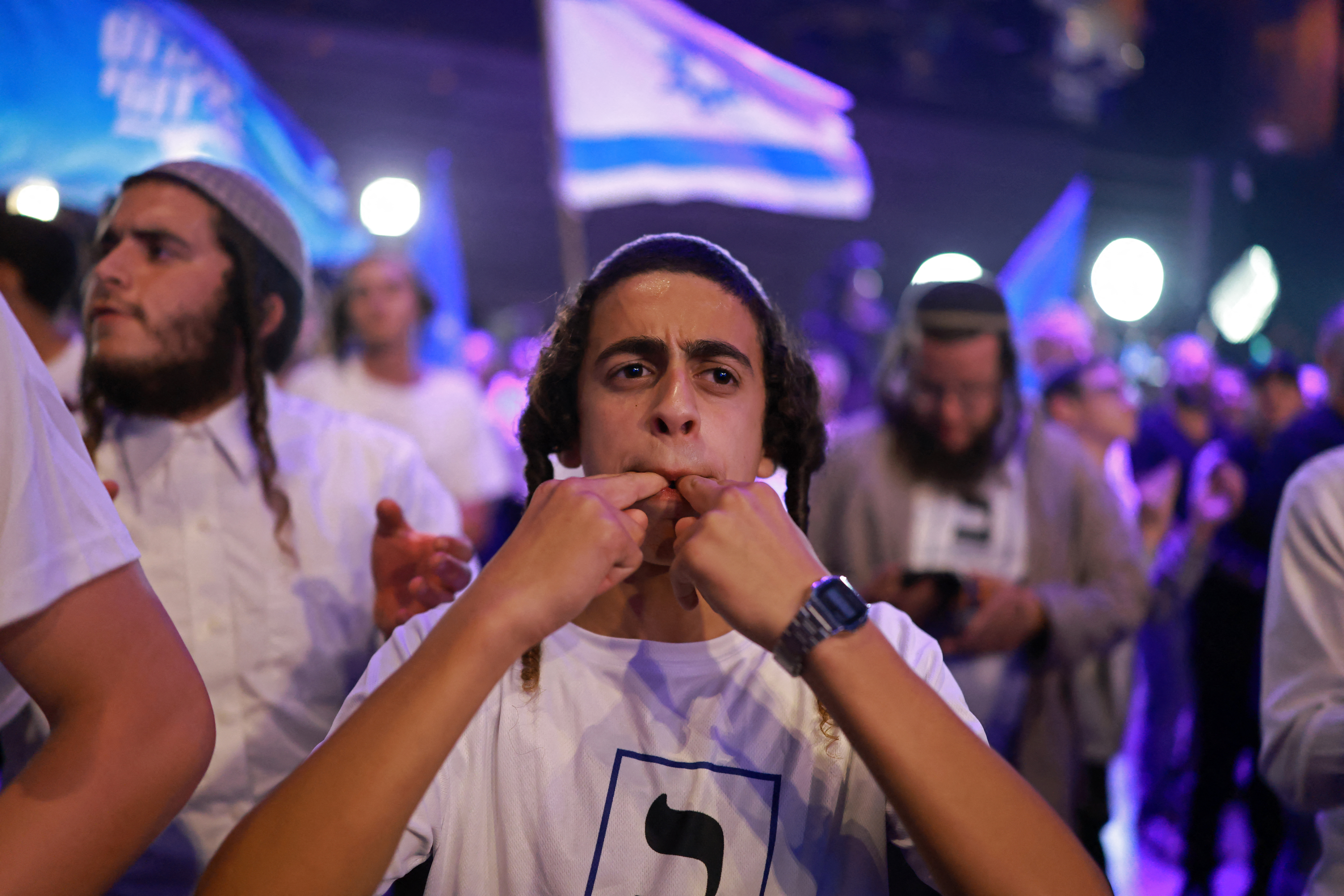 A supporter gestures while waiting for the arrival of far-right Otzma Yehudit party leader Itamar Ben Gvir, after the first exit polls were announced, in Modiin on October 27, 2026, during Israel's legislative elections. Israeli voters on October 27 gave a narrow edge to opposition parties over Prime Minister Benjamin Netanyahu, initial projections showed, after decades-high turnout in the country's first election since the trauma of the October 7, 2023 attacks. (Photo by Ilia YEFIMOVICH / AFP)