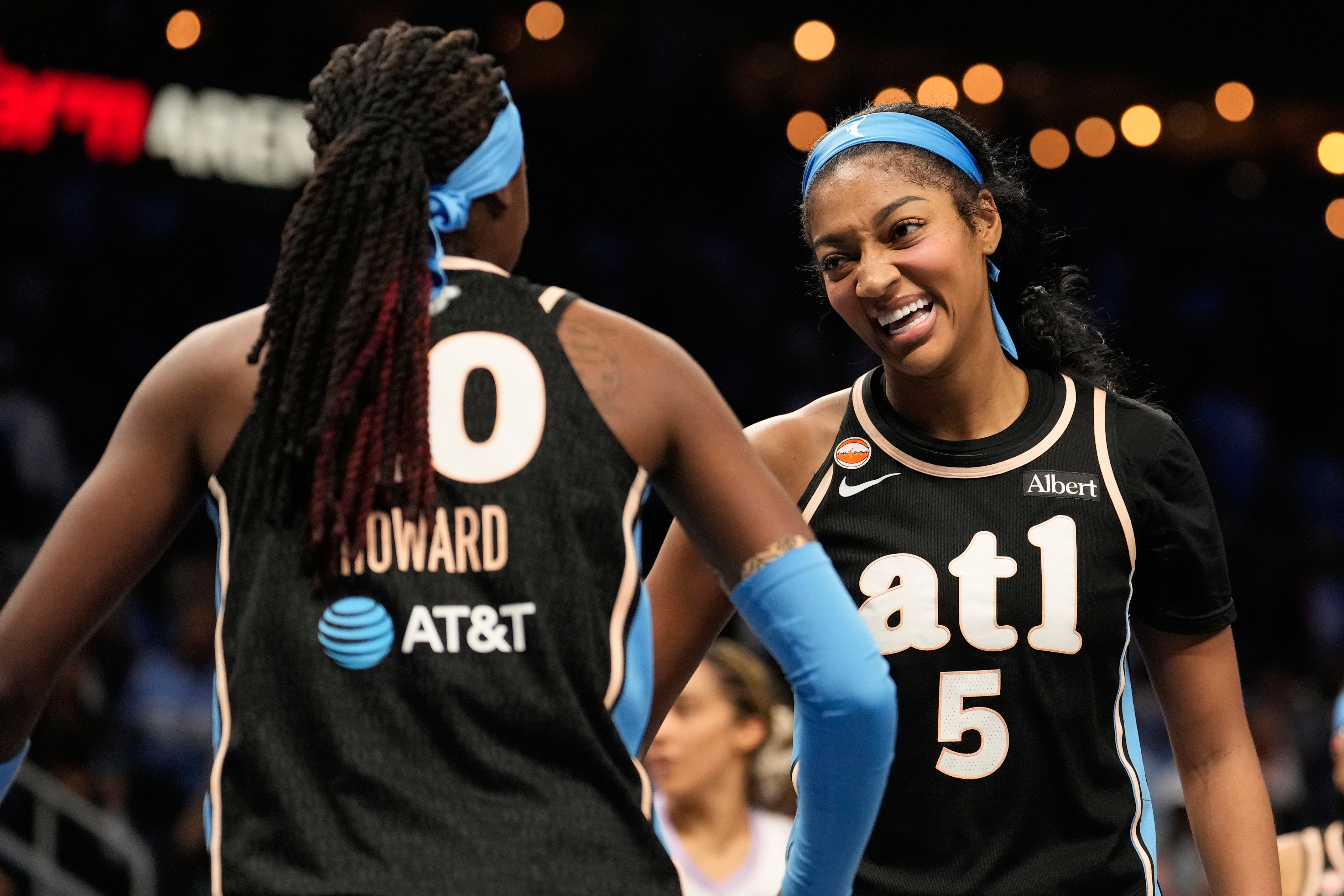 Atlanta Dream forward Angel Reese (5) and Atlanta Dream guard Rhyne Howard (10) react on court.