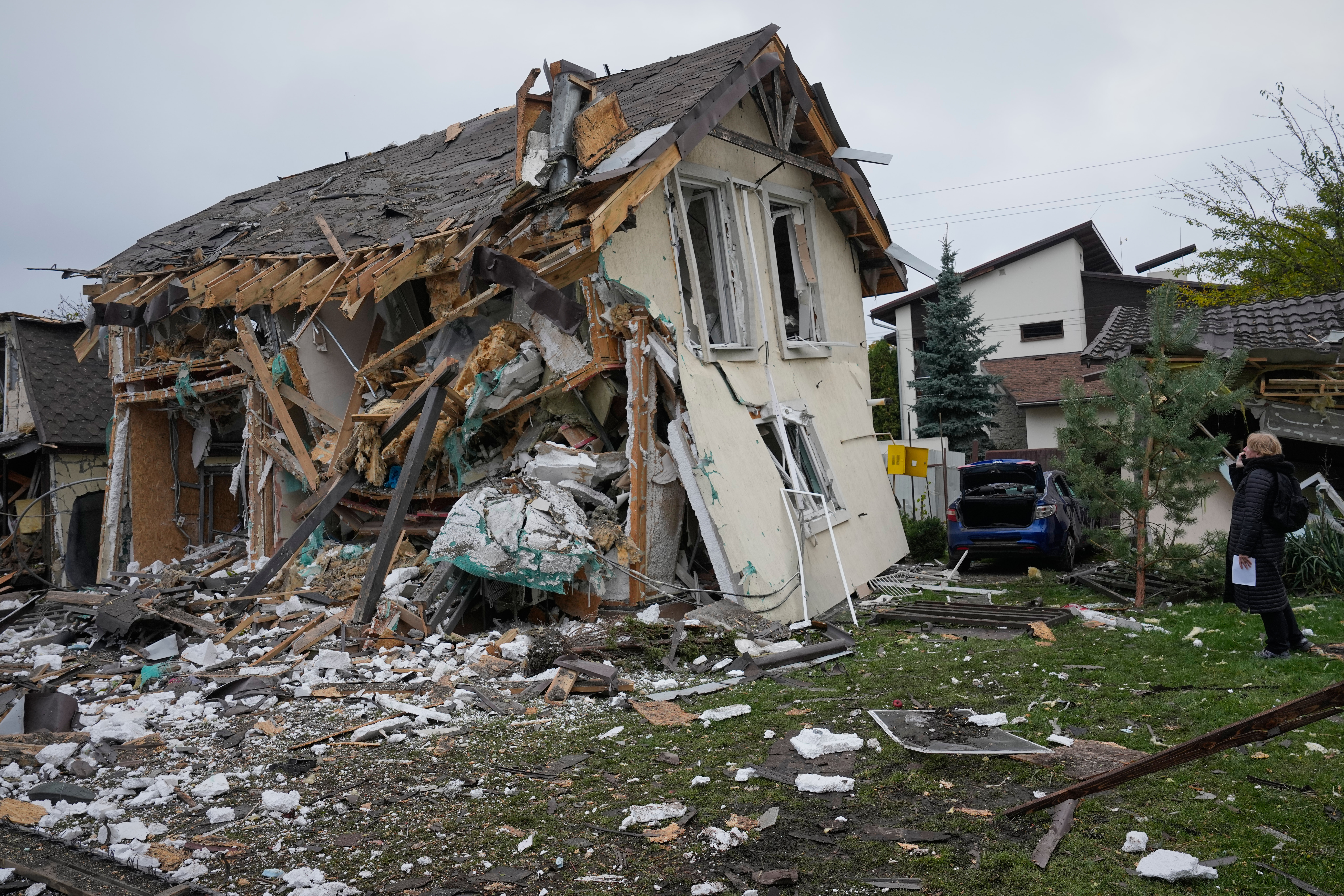 A woman looks at residential house destroyed in a Russian missile strike in Kyiv, Thursday, Oct. 22, 2026. (AP Photo/Efrem Lukatsky)