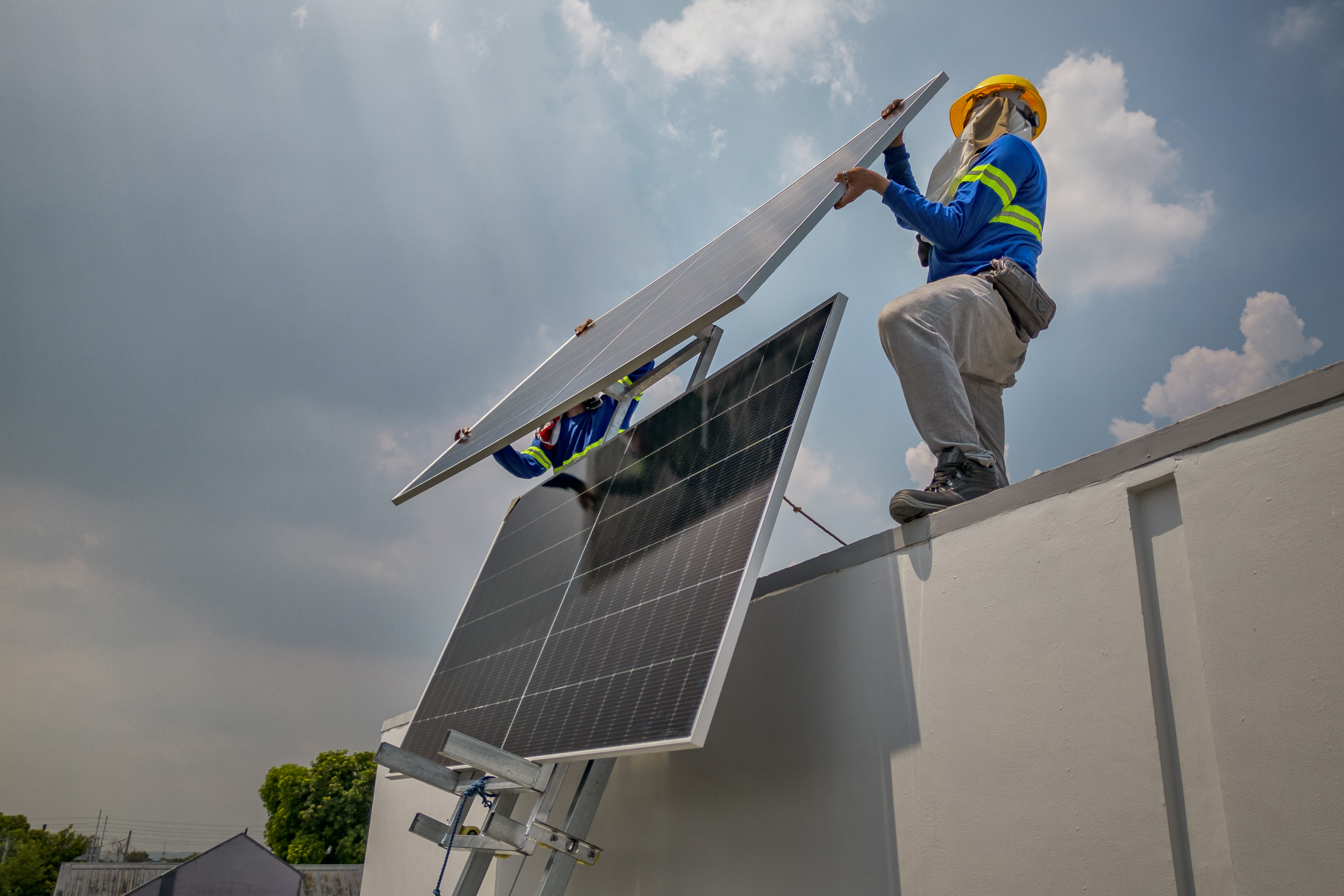 ANTIPOLO, PHILIPPINES - JULY 06: Workers from solar company Solva Energy use a lift to install solar panels on the roof of a house on July 06, 2026 in Antipolo, Philippines. The Philippines has emerged as one of the world’s biggest recent buyers of solar panels as households and businesses seek relief from some of Asia’s highest electricity prices, but the rapid boom is also raising concerns over land conversion, grid readiness, import dependence, and the impact of large-scale projects on farming communities. (Photo by Ezra Acayan/Getty Images)