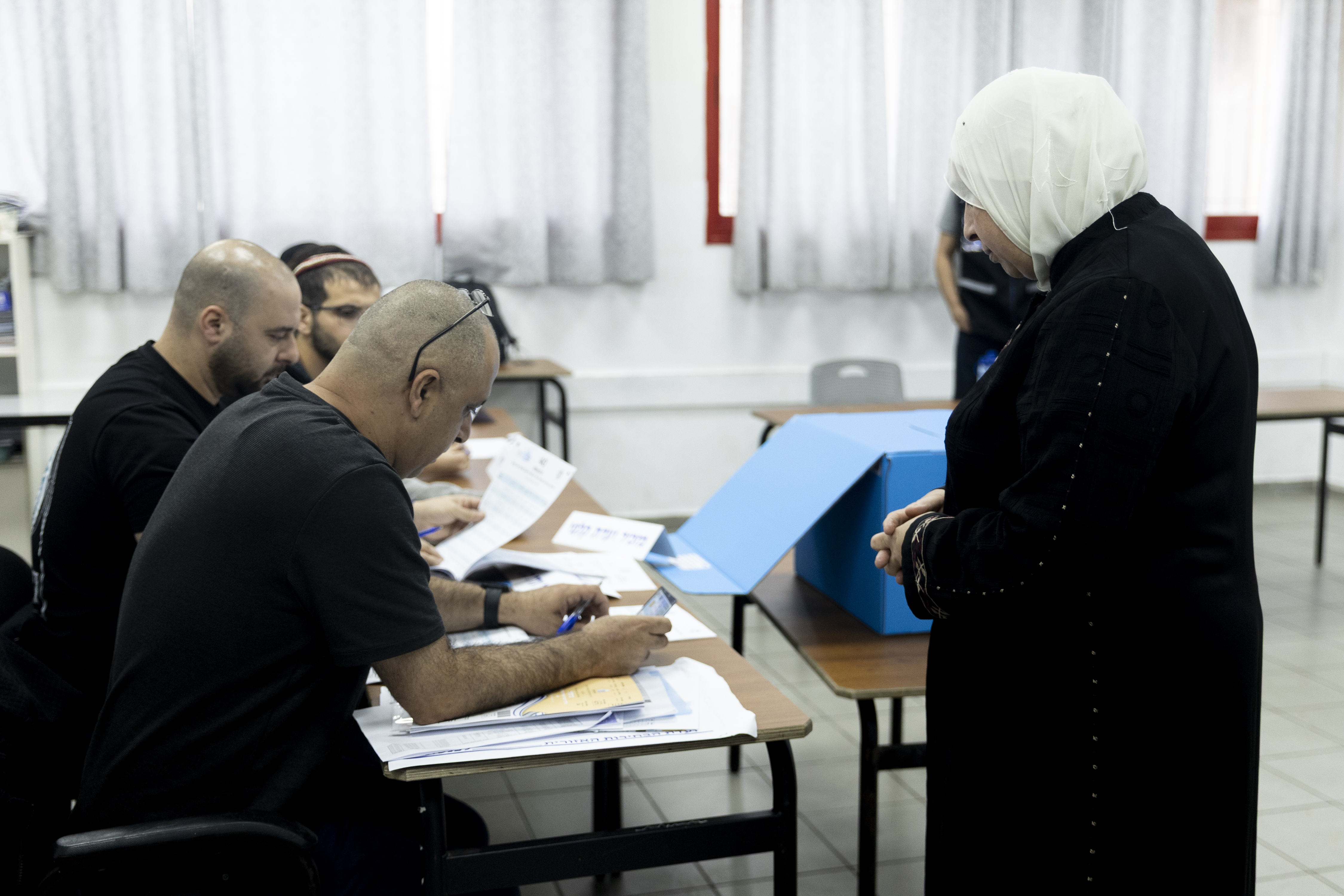 An Arab-Israeli woman casts her ballot during Israel's general elections on October 27, 2026 in Umm El Fahem, Israel