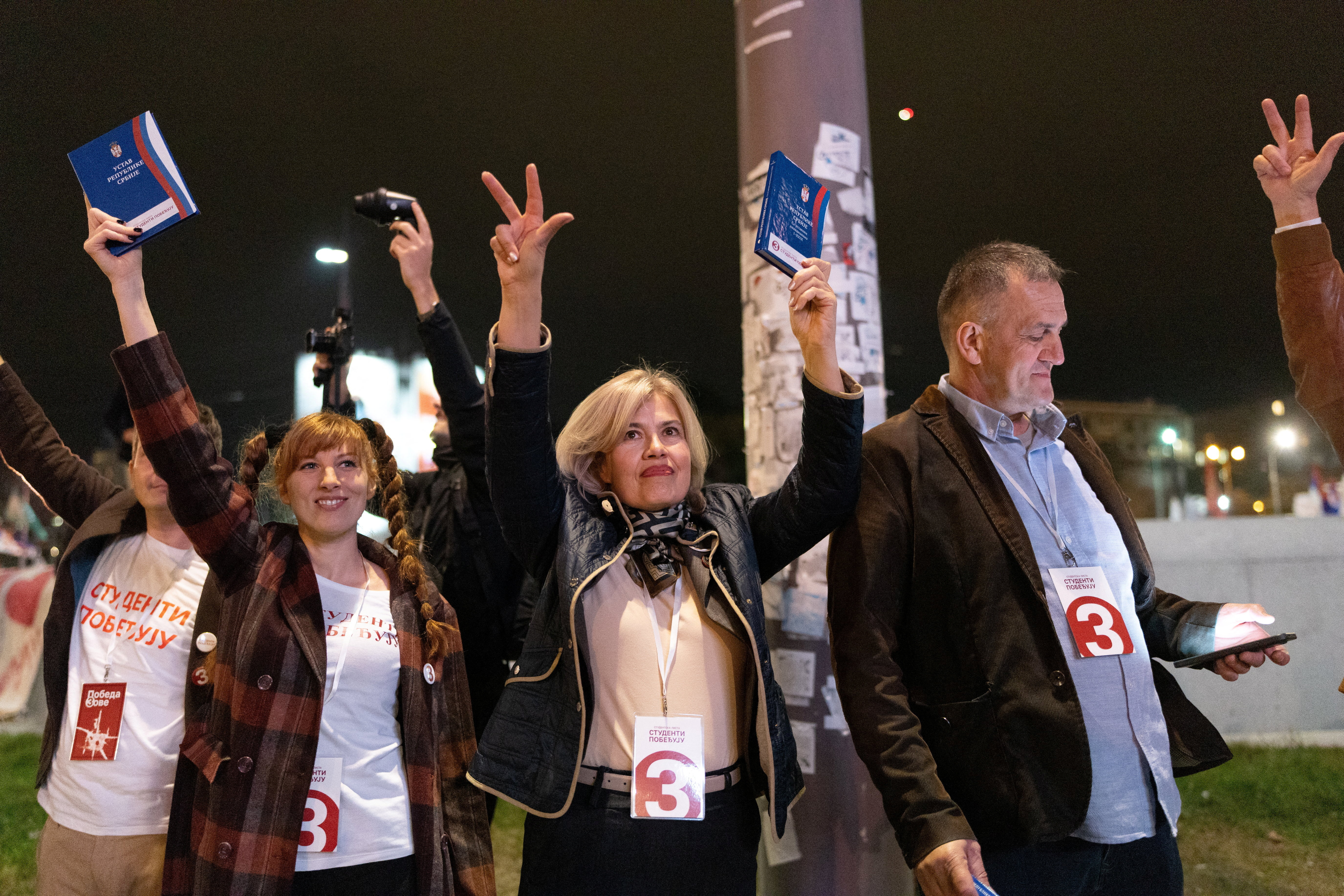 Parliament candidates of the electoral list "Student List - Students Win" hold copies of the Constitution of the Republic of Serbia during a final campaign rally at Slavija Square in Belgrade, Serbia, October 22, 2026. REUTERS/Uros Arsic