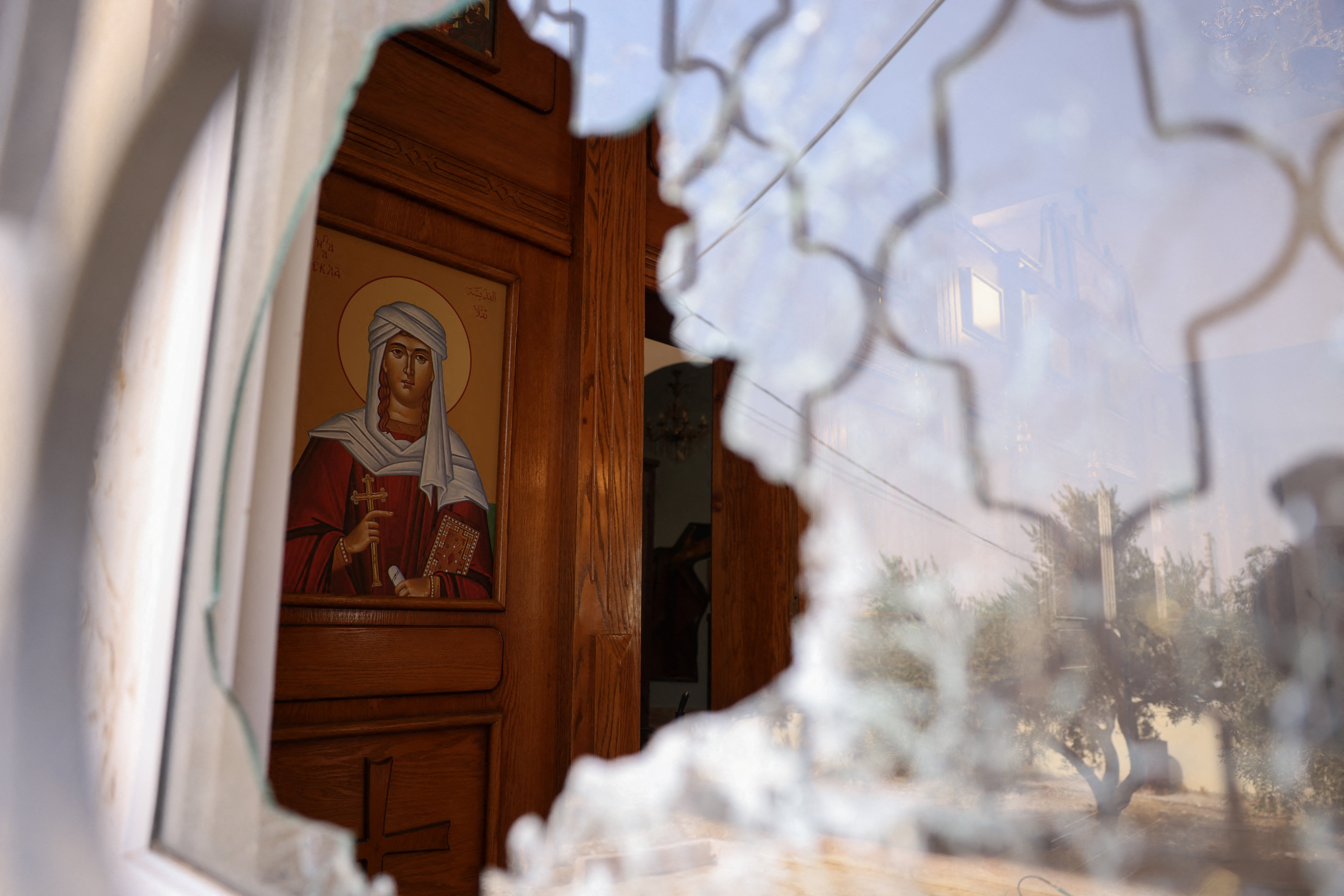 A shattered window at Saint George’s Greek Orthodox Church, where gunmen opened fire during a funeral the previous day, in the village of Hamoud, Karak, Jordan, October 24, 2026. REUTERS/Alaa Al Sukhni